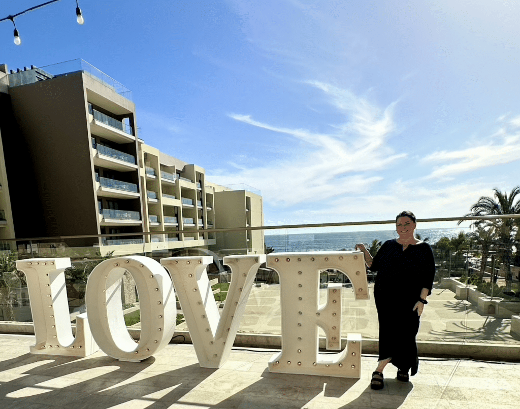 Dana Braun at Hard Rock Cabo during a destination wedding, with whales visible offshore